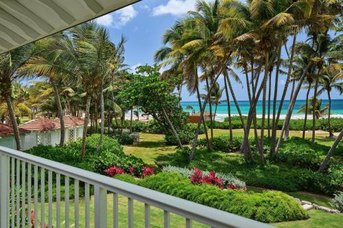a balcony view of the beach and palm trees at St. Regis Bahia Beach Resort, Puerto Rico in Rio Grande