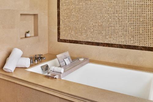 a bathroom with a bath tub and a sink at St. Regis Bahia Beach Resort, Puerto Rico in Rio Grande