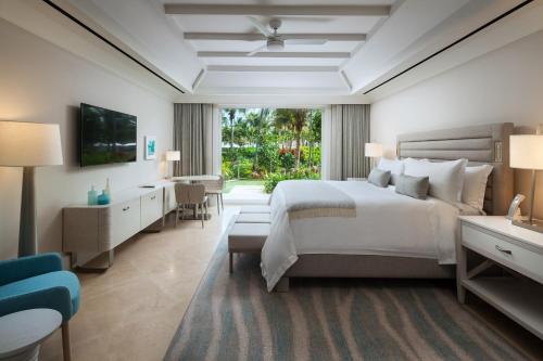 a hotel room with a bed and a living room at St. Regis Bahia Beach Resort, Puerto Rico in Rio Grande