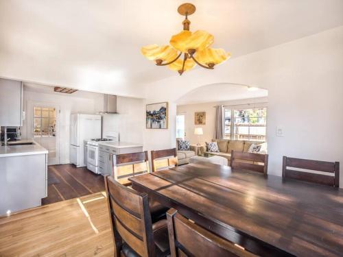 a kitchen and dining room with a large wooden table at Relaxing 3 bedroom Santa Cruz house, 5min to beach in Santa Cruz