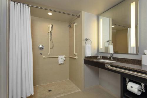 a bathroom with a shower and a sink at Renaissance Palm Springs Hotel in Palm Springs