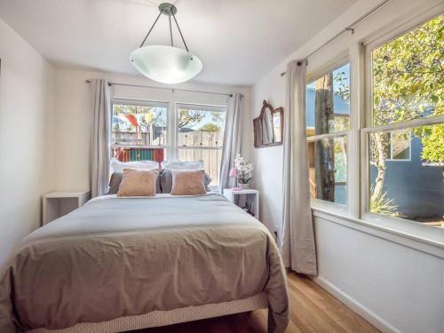 a bedroom with a bed and a large window at Relaxing 3 bedroom Santa Cruz house, 5min to beach in Santa Cruz