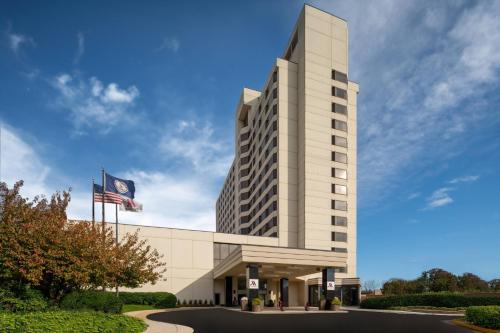 a tall white building with an american flag at Tysons Corner Marriott in Tysons Corner