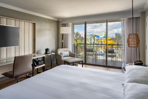 a hotel room with a large bed and a balcony at Orlando World Center Marriott in Orlando