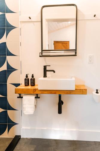 a bathroom with a sink and a mirror at Mini Shortboard Room with a Queen Bed in Stinson Beach