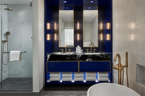 a bathroom with a sink and a mirror at Marriott Bethesda Downtown at Marriott HQ in Bethesda