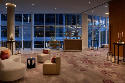 a lobby with couches and chairs in a building at Marriott Bethesda Downtown at Marriott HQ in Bethesda