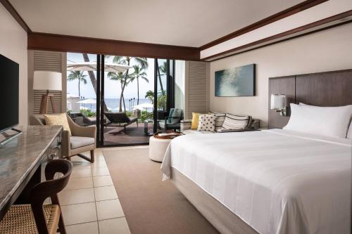 a bedroom with a large bed and a living room at Wailea Beach Resort - Marriott, Maui in Wailea