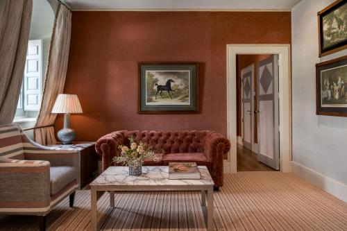 a living room with a couch and a table at Santo Mauro, a Luxury Collection Hotel, Madrid in Madrid