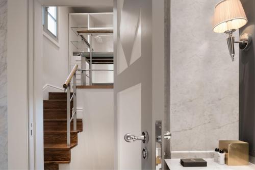 a bathroom with a staircase and a door with a lamp at Santo Mauro, a Luxury Collection Hotel, Madrid in Madrid