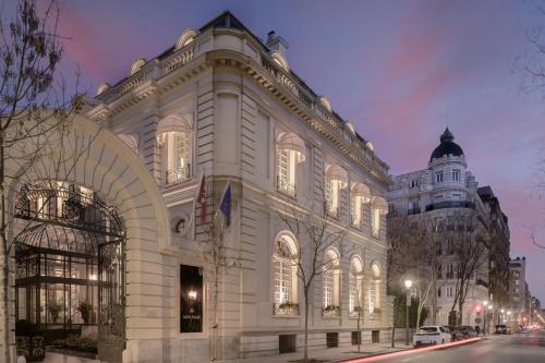 a large white building with lights on at Santo Mauro, a Luxury Collection Hotel, Madrid in Madrid