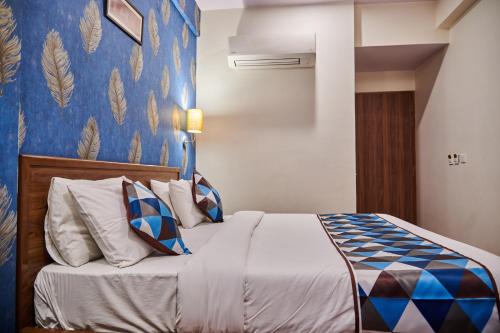 a bedroom with a bed with a blue wall at The Sarai, Hotel in Jaipur