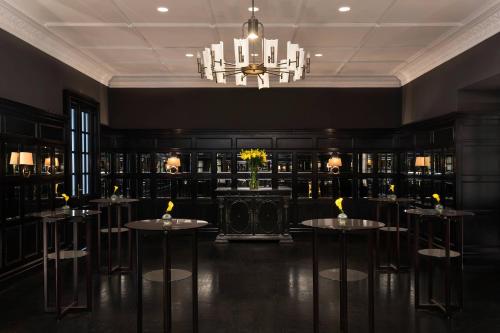a dining room with tables and a chandelier at Hotel Bristol, A Luxury Collection Hotel, Warsaw in Warsaw