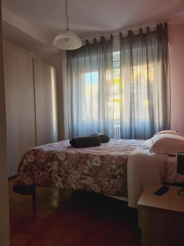 a bedroom with a large bed with a window at P in centro in Sestri Levante