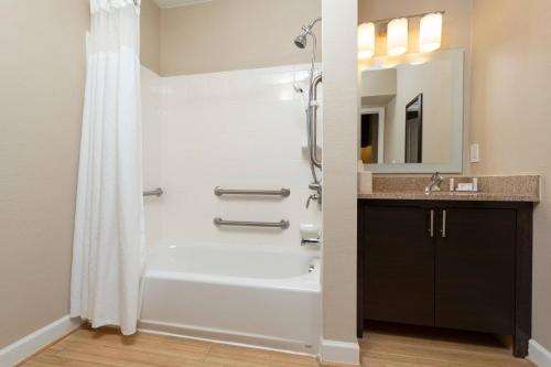 a bathroom with a shower and a sink at TownePlace Suites Wilmington Wrightsville Beach in Wilmington