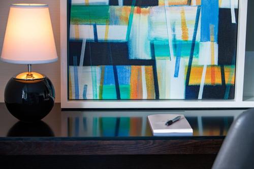 a table with a lamp and a book and a pen at JW Marriott Essex House New York in New York