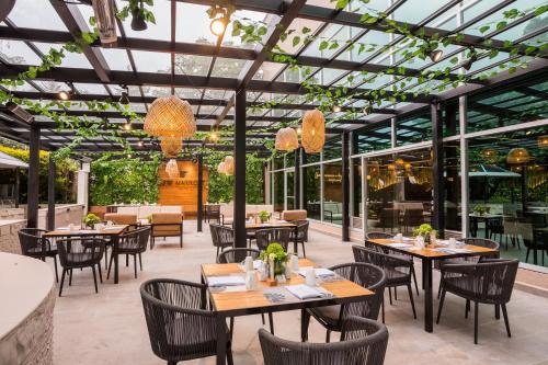 a restaurant with tables and chairs and windows at JW Marriott Quito in Quito