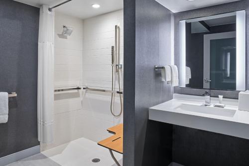 a bathroom with a shower and a sink and a tub at Marriott Lexington Griffin Gate Golf Resort & Spa in Lexington