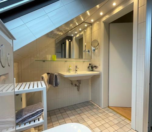 a bathroom with a sink and a mirror at Haus Sigge Ferienwohnungen in Bad Sassendorf