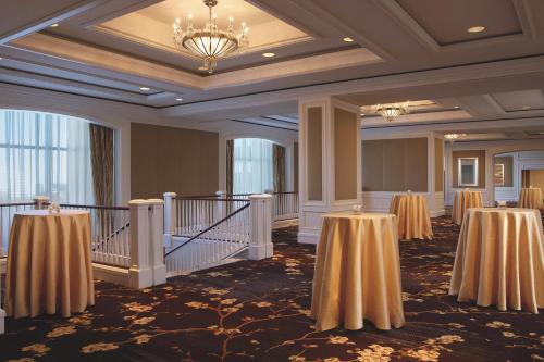 a banquet room with tables and a chandelier at The Ritz-Carlton, Tysons Corner in Tysons Corner