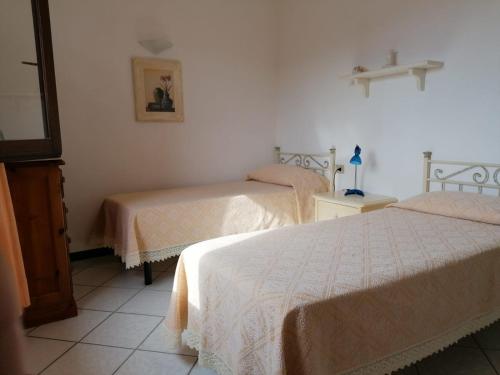 a room with two beds in a room at Le Canne Apt 1 in San Teodoro