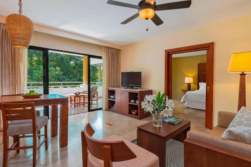 a living room with a room with a bed and a table at The Westin Reserva Conchal, an All-Inclusive Golf Resort & Spa in Playa Conchal