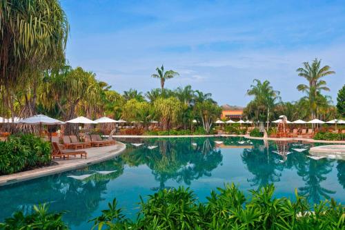 a pool at a resort with chairs and umbrellas at The Westin Reserva Conchal, an All-Inclusive Golf Resort & Spa in Playa Conchal