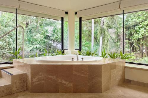 a large bathroom with a tub and large windows at The Westin Reserva Conchal, an All-Inclusive Golf Resort & Spa in Playa Conchal