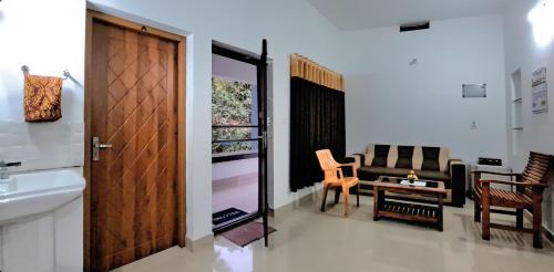 a living room with a couch and a table at Pearl Inn in Kottakkal