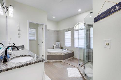 a bathroom with a tub and a sink and a shower at Dog-Friendly Home with Pool and Yard in Bradenton in Bradenton
