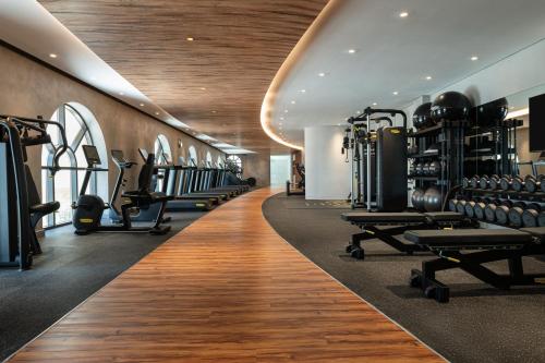 a fitness room with a gym with tread machines at Le Royal Méridien Place Vendôme Lusail in Doha