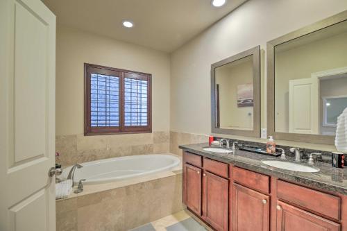 a bathroom with a tub and a sink at East Dtwn Houston Vacation Rental Near Stadiums in Houston