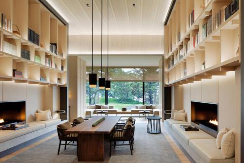 a living room with a table and a fireplace at The Ritz-Carlton, Nikko in Nikko