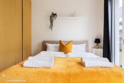 a bedroom with a large bed with two pillows on it at Pineapple Apartments Dresden Altstadt II - 124 qm - 1x free parking in Dresden