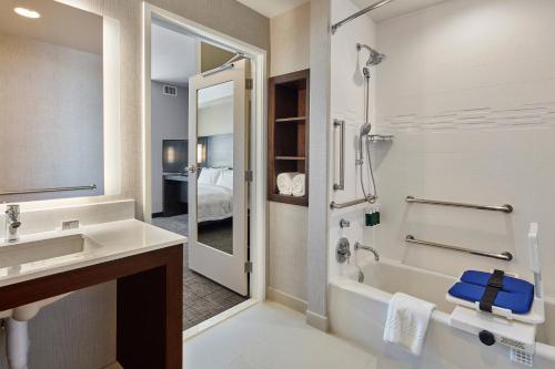 uma casa de banho com uma banheira, um lavatório e um chuveiro em Residence Inn Sacramento Davis em Davis