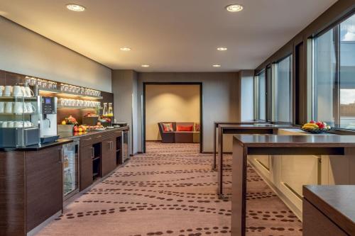 a large kitchen with counters and tables and windows at Frankfurt Marriott Hotel in Frankfurt/Main