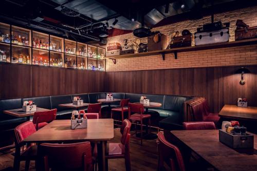 a restaurant with wooden walls and tables and chairs at Frankfurt Marriott Hotel in Frankfurt/Main