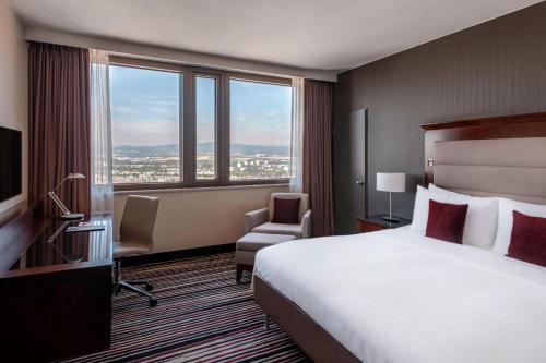 a hotel room with a bed and a large window at Frankfurt Marriott Hotel in Frankfurt/Main