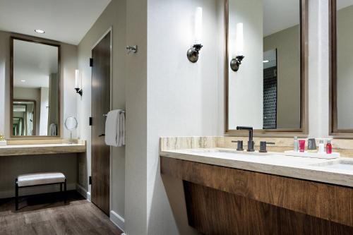 a bathroom with a sink and a mirror at Houston CityPlace Marriott at Springwoods Village in The Woodlands