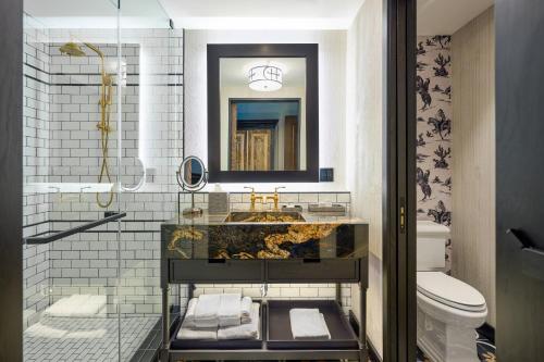 a bathroom with a sink and a toilet at Hotel Drover, Autograph Collection in Fort Worth