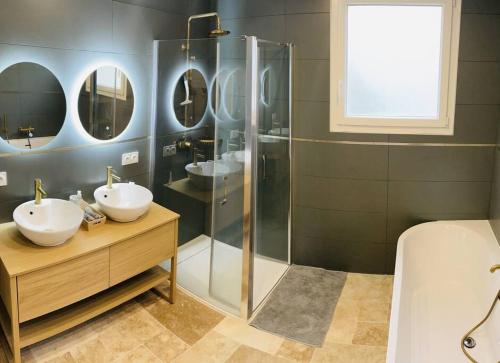 a bathroom with two sinks and a shower with mirrors at La Villa Candau - Cowork & Fun - Piscine - Wifi Fibre in Les Angles Gard
