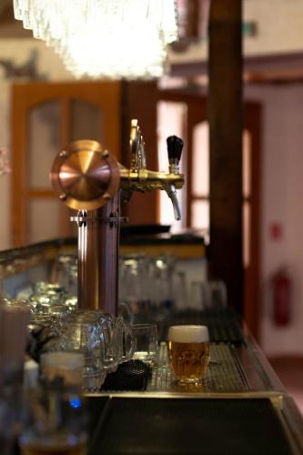 a bar with two glasses of beer on a table at Penzión Pegas in Bratislava