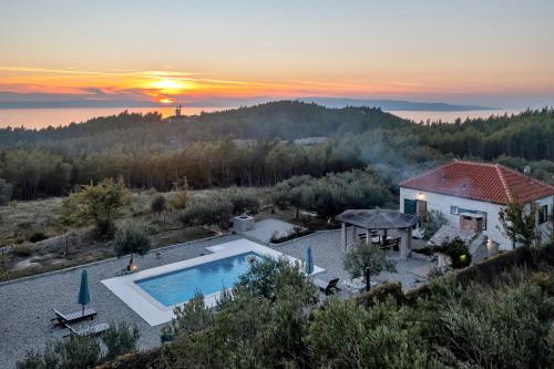 an aerial view of a house with a swimming pool at Villa Natura Makarska in Makarska