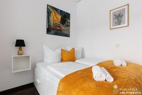 a bedroom with a white bed with towels on it at Pineapple Apartments Palais am Neumarkt - 90 qm - 1x free parking in Dresden