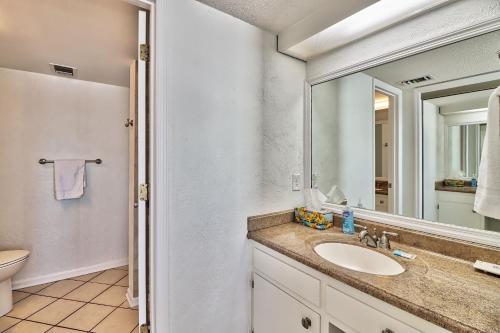 a bathroom with a sink and a mirror at Direct Ocean Front 3BR/2BA Dog Friendly in Myrtle Beach