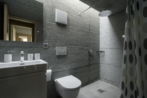 a bathroom with a toilet and a sink and a shower at Mayen à Madeleine in Haudères