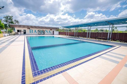 a large swimming pool in front of a building at Banana Resort Sadao in Sadao