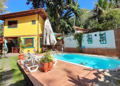 a swimming pool in front of a house at Pousada Estalagem Paraty in Paraty