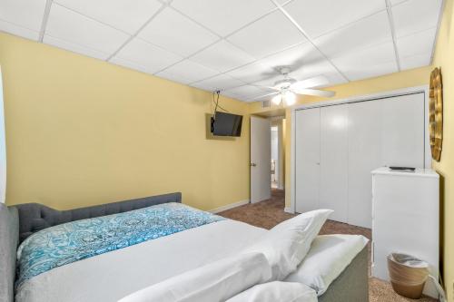 a bedroom with a bed and a ceiling fan at The Treehouse On the Bay in Pensacola Beach