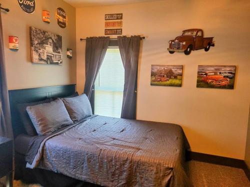 a bedroom with a bed and a truck on the wall at King Bed In Main Floor - Downtown Vacation Rental in Kalamazoo